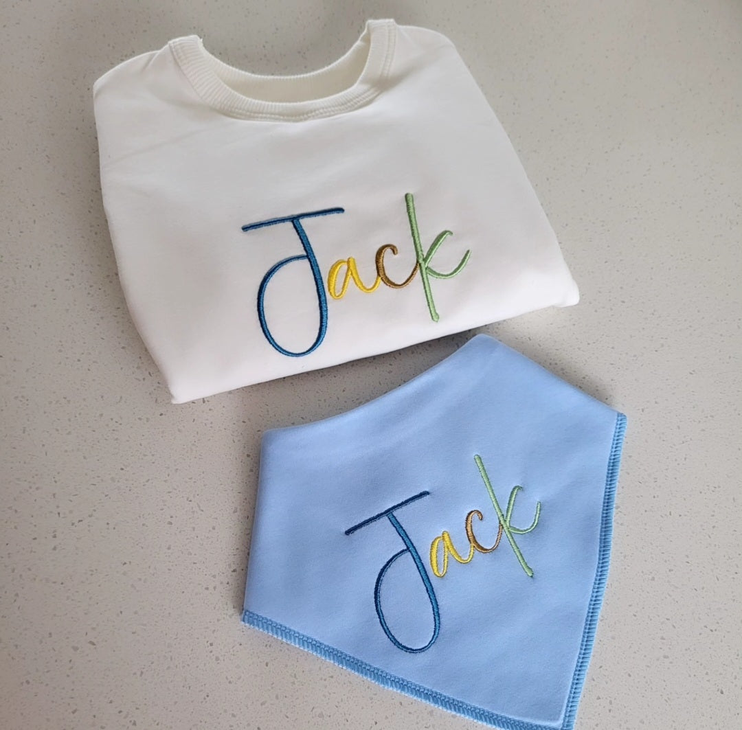 Matching multicolored babygrow & bib set.