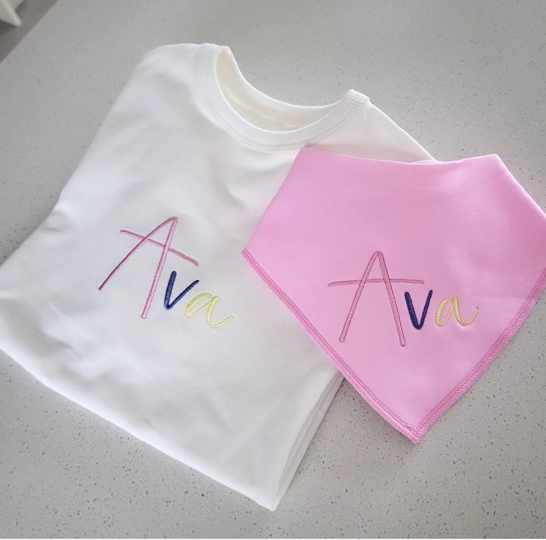 Matching multicolored babygrow & bib set.