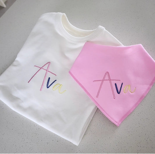Matching multicolored babygrow & bib set.