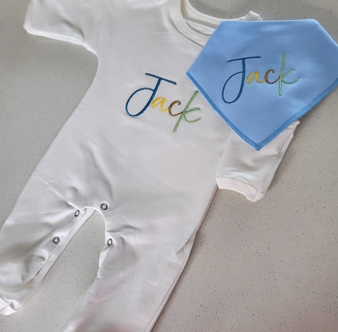 Matching multicolored babygrow & bib set.