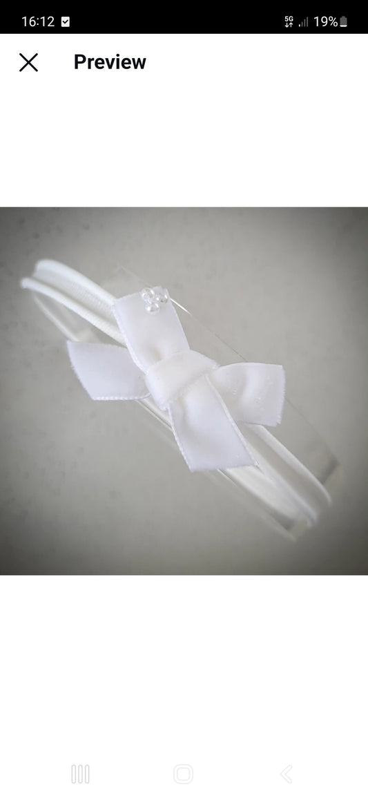 Hand-tied white velvet bow