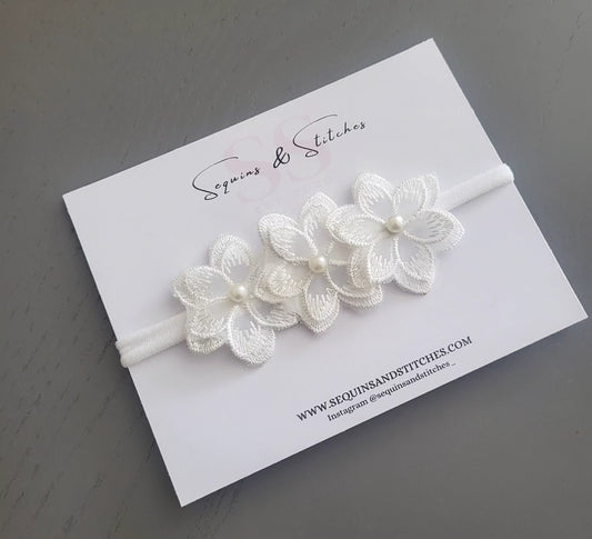 Off white floral headpice with pearl centre.
